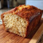 Close-up of a freshly baked loaf of greek yogurt banana bread showing its moist crumb texture.
