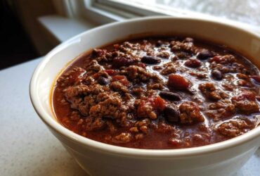 Close-up of a rich, hearty bowl of chili loaded with ground beef and kidney beans, perfect for the best chili recipe.
