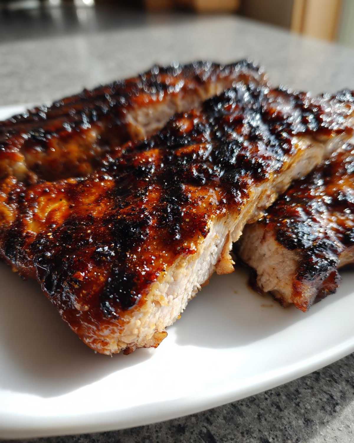 Close-up of thick, juicy pork steak recipe cuts showing a caramelized, dark glaze and tender interior.