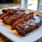 Close-up of medium-rare sliced steak coated in a rich glaze, showing the results of the carne asada marinade.