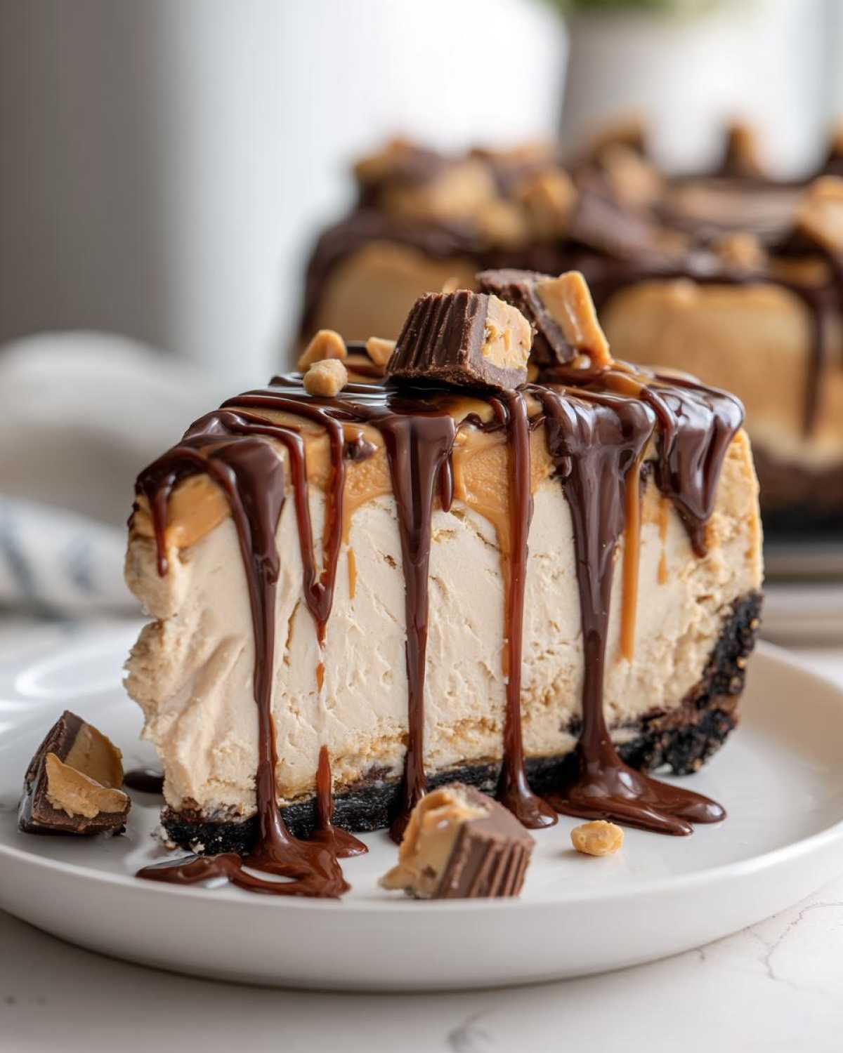 A decadent slice of Chocolate Peanut Butter Cheesecake Dip topped with chocolate sauce and peanut butter cups.