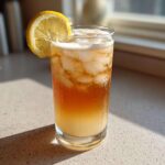 A tall glass filled with ice, Cold Brew Lemonade, and topped with a lemon slice.