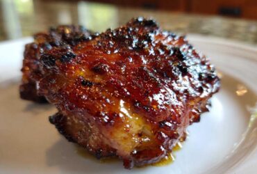 Close-up of a perfectly cooked Spicy Honey Garlic Air Fryer Chicken Thigh with a thick, caramelized glaze.