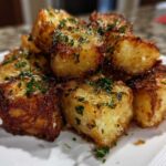 Close-up of golden brown, crispy Air Fryer Crispy Garlic Parmesan Potato Cubes garnished with fresh parsley.