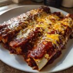 Three rolled chicken enchiladas smothered in rich red sauce and topped with melted cheddar and Monterey Jack cheese.