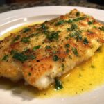 Close-up of a perfectly cooked fillet in an Easy Flounder Francese Recipe, glistening with lemon butter sauce and topped with parsley.