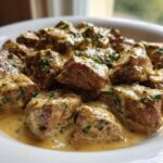 Close-up of Easy One-Pan Creamy Garlic Steak Bites covered in rich sauce and sprinkled with parsley.