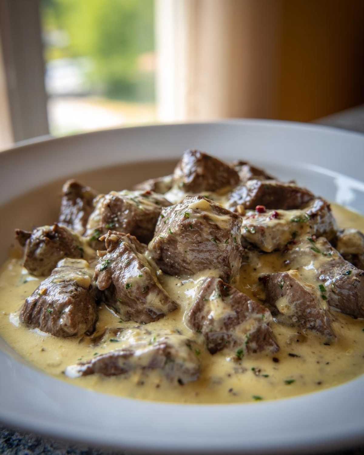 Close-up of juicy steak bites smothered in a creamy garlic sauce, perfect for Easy One-Pan Creamy Garlic Steak Bites.