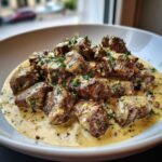 Close-up of Easy One-Pan Creamy Garlic Steak Bites smothered in a rich, creamy garlic sauce and topped with fresh parsley.