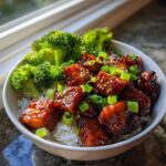 Close-up of Honey Sriracha Chicken Rice Bowls featuring glazed chicken, white rice, and steamed broccoli.