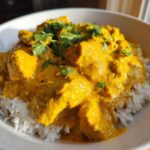 Close-up of Instant Pot Creamy Coconut Chicken Curry served over fluffy white rice and garnished with fresh cilantro.