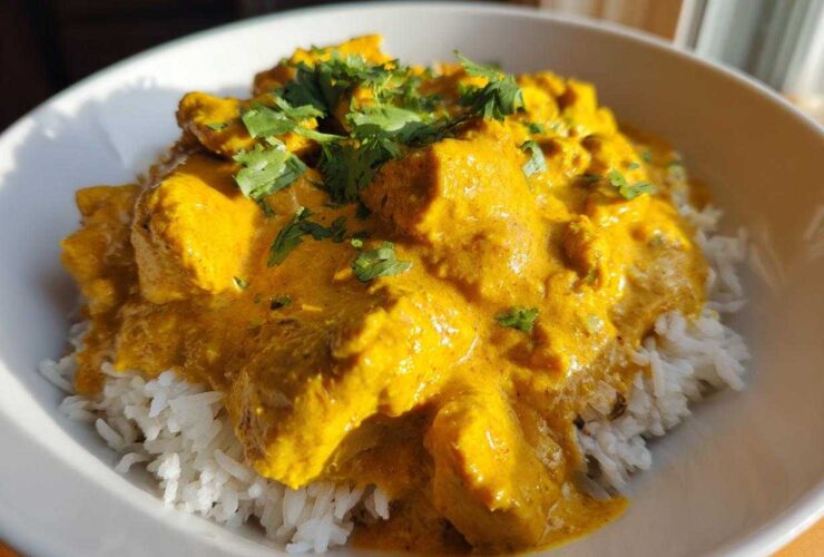 Close-up of Instant Pot Creamy Coconut Chicken Curry served over fluffy white rice and garnished with fresh cilantro.