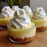Close-up of individual No-Bake Lemon Cream Pie Cups topped with whipped cream and lemon zest.