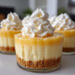 Close-up of individual No-Bake Lemon Cream Pie Cups topped with whipped cream and lemon zest.
