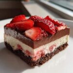 A perfect square slice of No-Bake Strawberry Chocolate Pudding Pie showing four distinct layers.