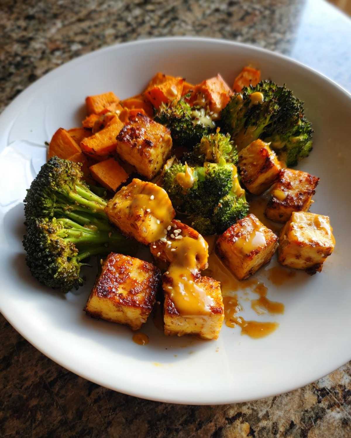 Plate of Sheet Pan Crispy Honey Mustard Tofu served with roasted broccoli and sweet potatoes.