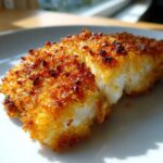Close-up of a perfectly cooked Air Fryer Panko Cod Fillets showing flaky white fish and a golden-brown, crispy panko crust.