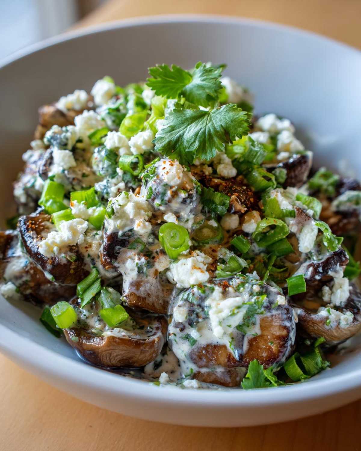 Close-up of Mexican Street Corn Salad MushroomSalus featuring roasted mushrooms topped with creamy sauce, cotija cheese, and green onions.