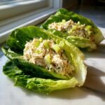 Two fresh tuna salad lettuce wraps showing the creamy filling and celery chunks, illustrating the Easiest Way to Eat.