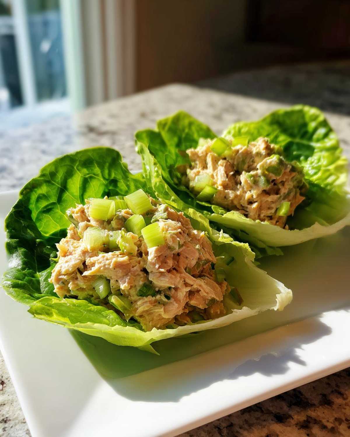 Two servings of tuna salad nestled in crisp lettuce cups, showing the Easiest Way to Eat for a quick meal.
