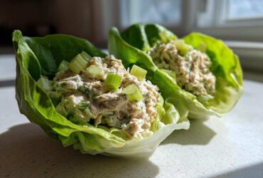 Two fresh tuna salad lettuce wraps topped with chopped celery, showing the Easiest Way to Eat lunch.