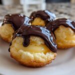Four delicious Boston Cream Pie Cookie Bites filled with custard and topped with dripping dark chocolate ganache.
